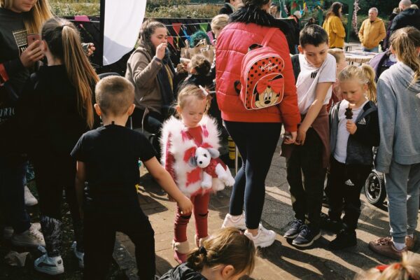 Children wait in the queue for facepainting, at the Women AgainstCapitalism ‘Care and Share’ event,Castlemilk.